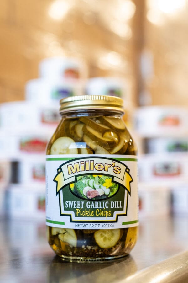 A jar of pickles sitting on top of a table.