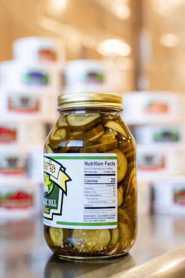 A jar of pickles sitting on top of a table.