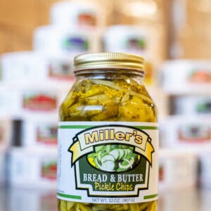 A jar of pickles sitting on top of a table.
