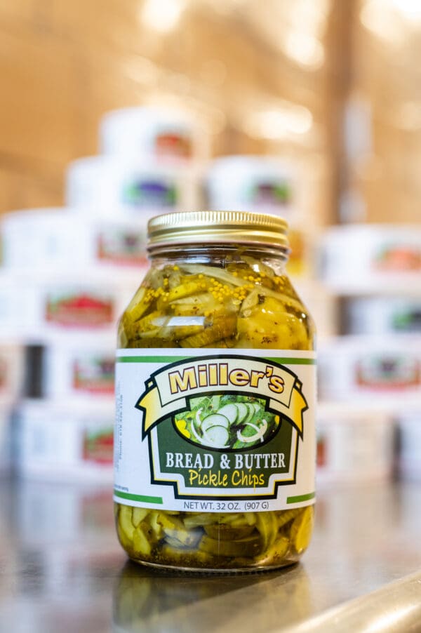 A jar of pickles sitting on top of a table.