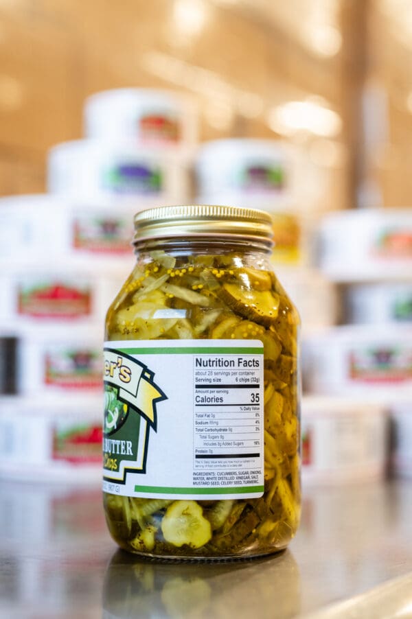 A jar of pickles sitting on top of a table.