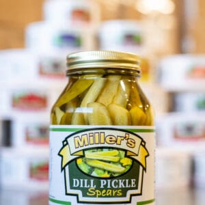 A jar of pickles sitting on top of a table.