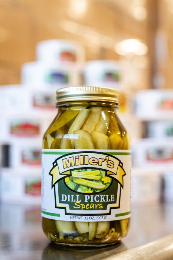 A jar of pickles sitting on top of a table.