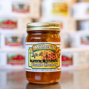 A jar of honey sitting on top of a table.