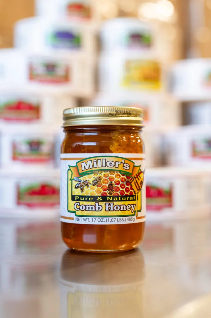 A jar of honey sitting on top of a table.