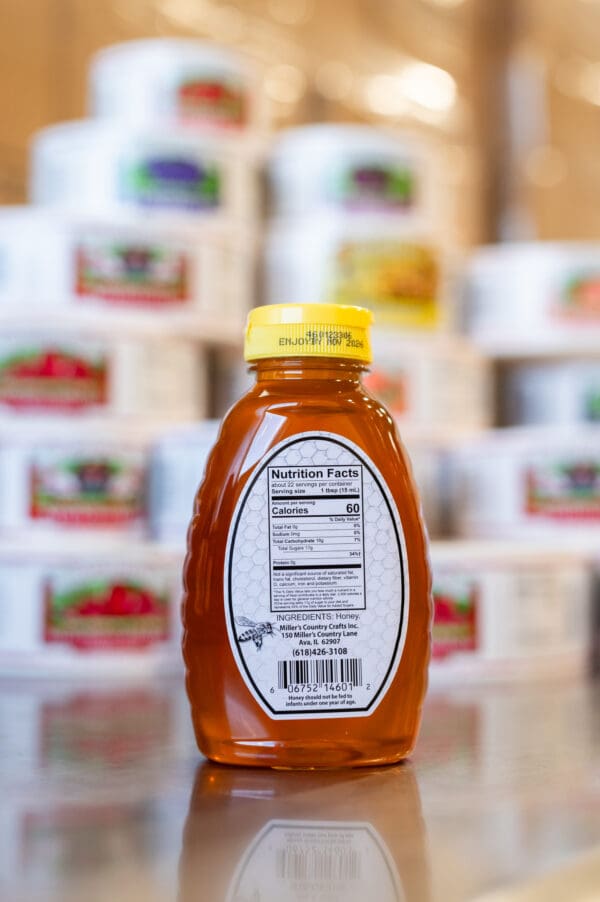 A bottle of honey is in front of many other boxes.