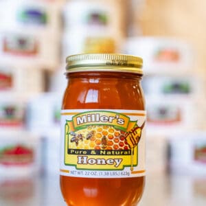 A jar of honey sitting on top of a table.