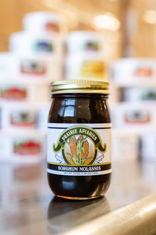 A jar of honey sitting on top of a table.