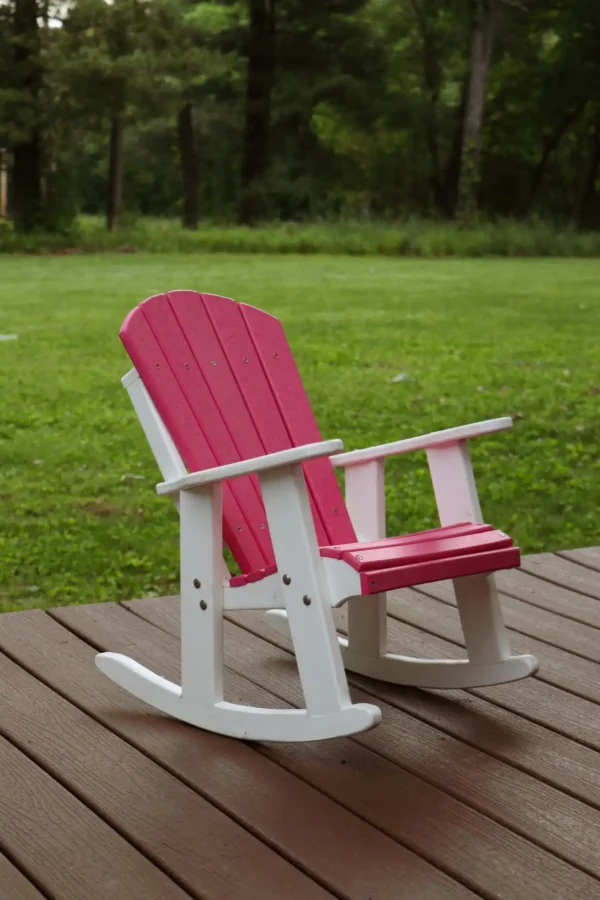 A pink and white rocking chair on the deck